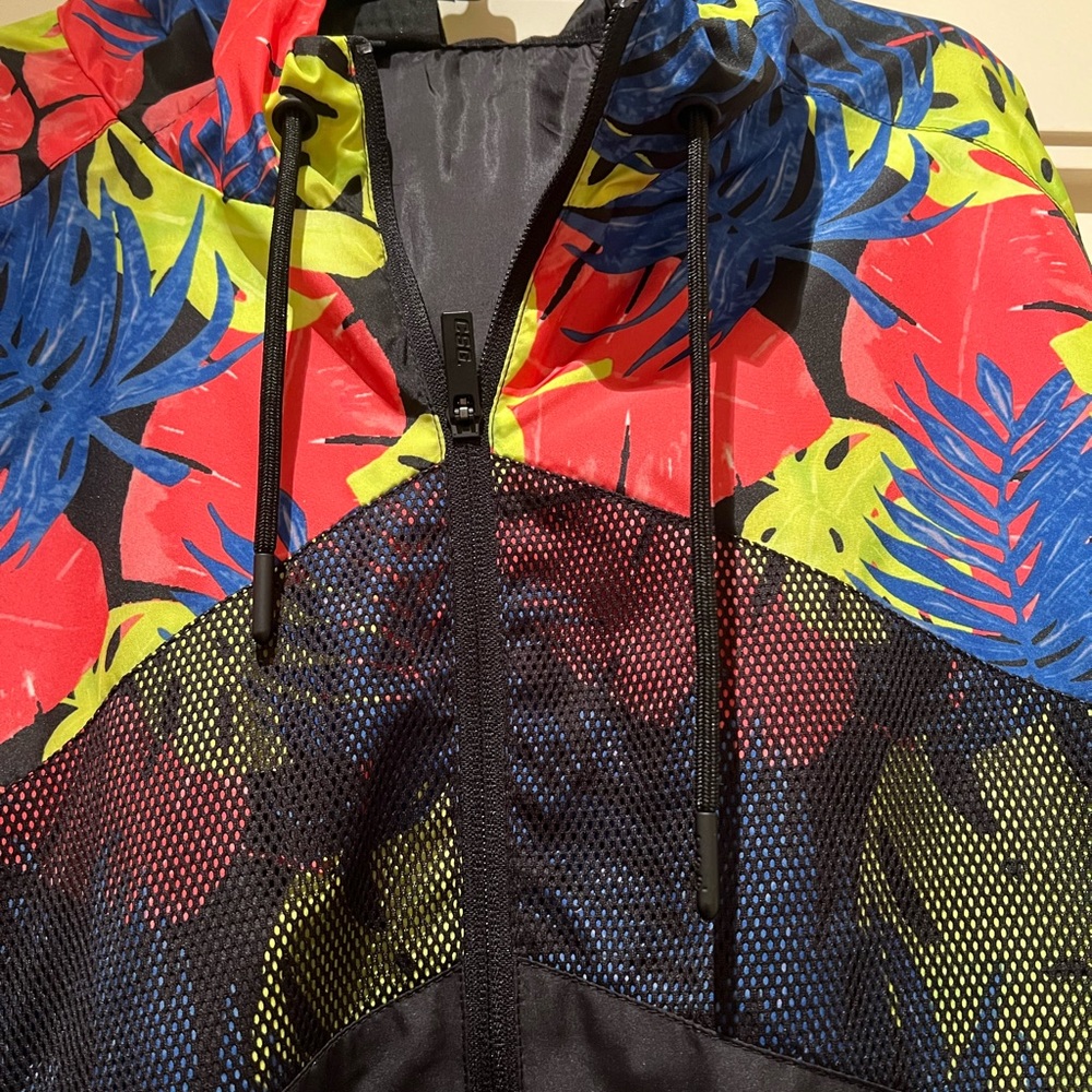 Black nylon jacket with tropical design.